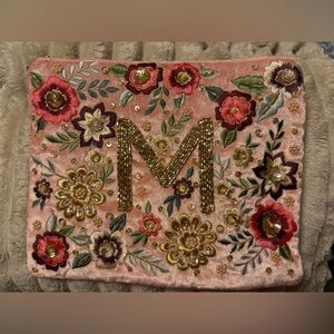 Floral Embroidered Clutch with Gold Initial “M” on Velvet Background